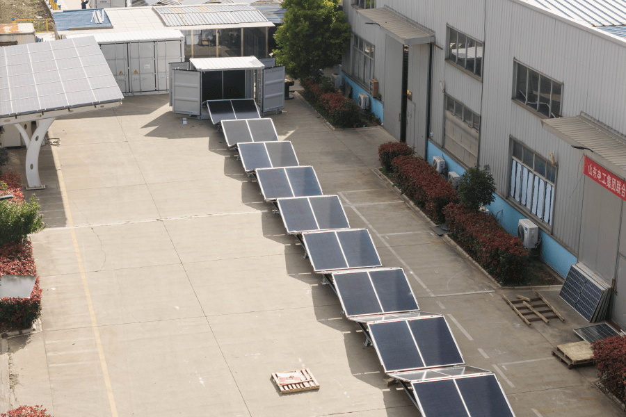 Two pre-integrated energy storage containers deployed at the perimeter of a large industrial manufacturing facility